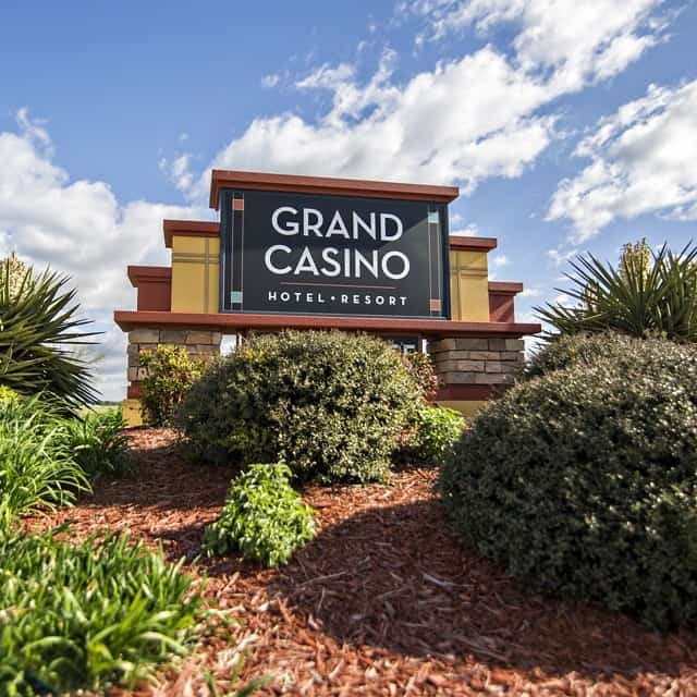 Grand Casino hotel resort sign with landscaping and blue sky, Los Angeles area.