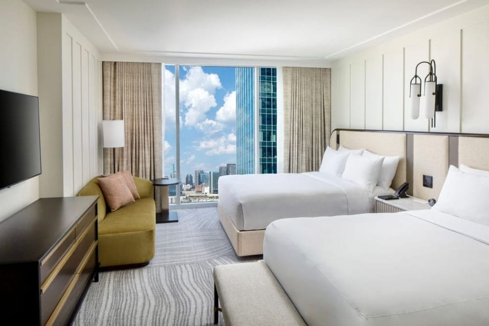 Modern hotel room with city views, comfortable beds, and stylish amenities for travelers seeking convenience and luxury.