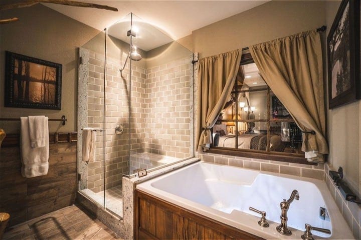 Luxury bathroom with walk-in shower and soaking tub, cozy rustic decor, ideal for relaxing stays.