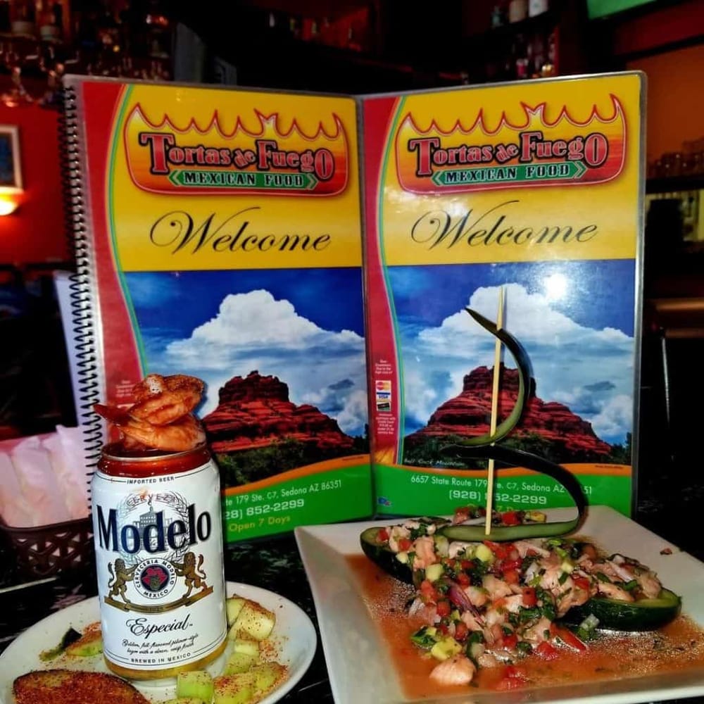 Colorful Mexican restaurant menu with ceviche and Modelo beer, vibrant decor, and welcoming atmosphere.
