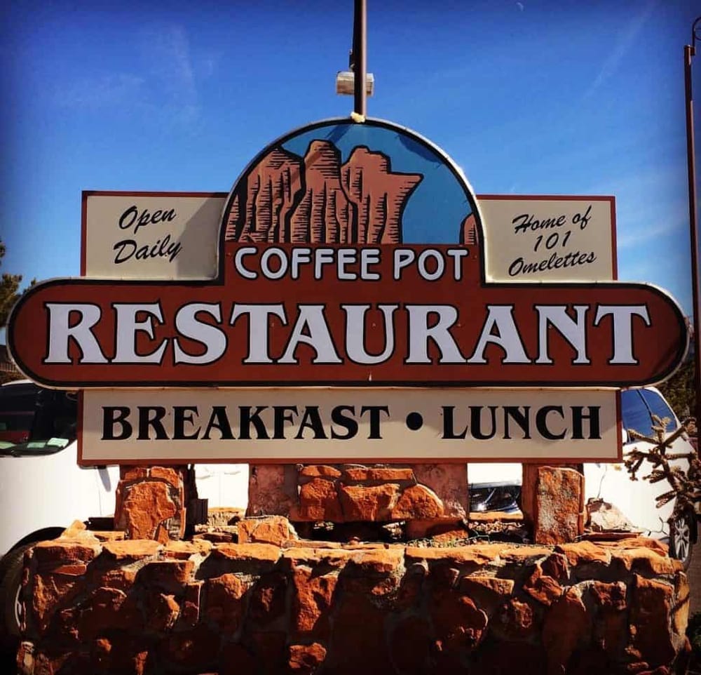 Spacious coffee pot restaurant sign with breakfast and lunch menu, inviting outdoor dining experience.