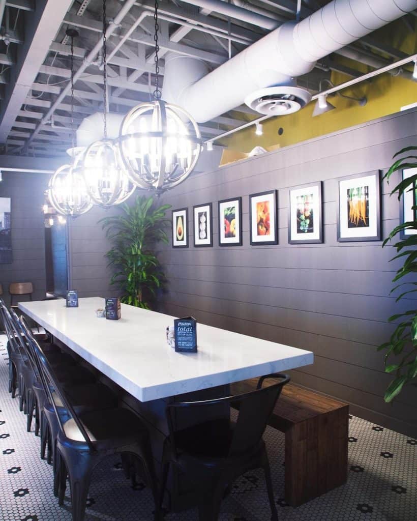 Bright modern cafe interior with contemporary lighting and framed artwork, creating a cozy, stylish atmosphere for dining.