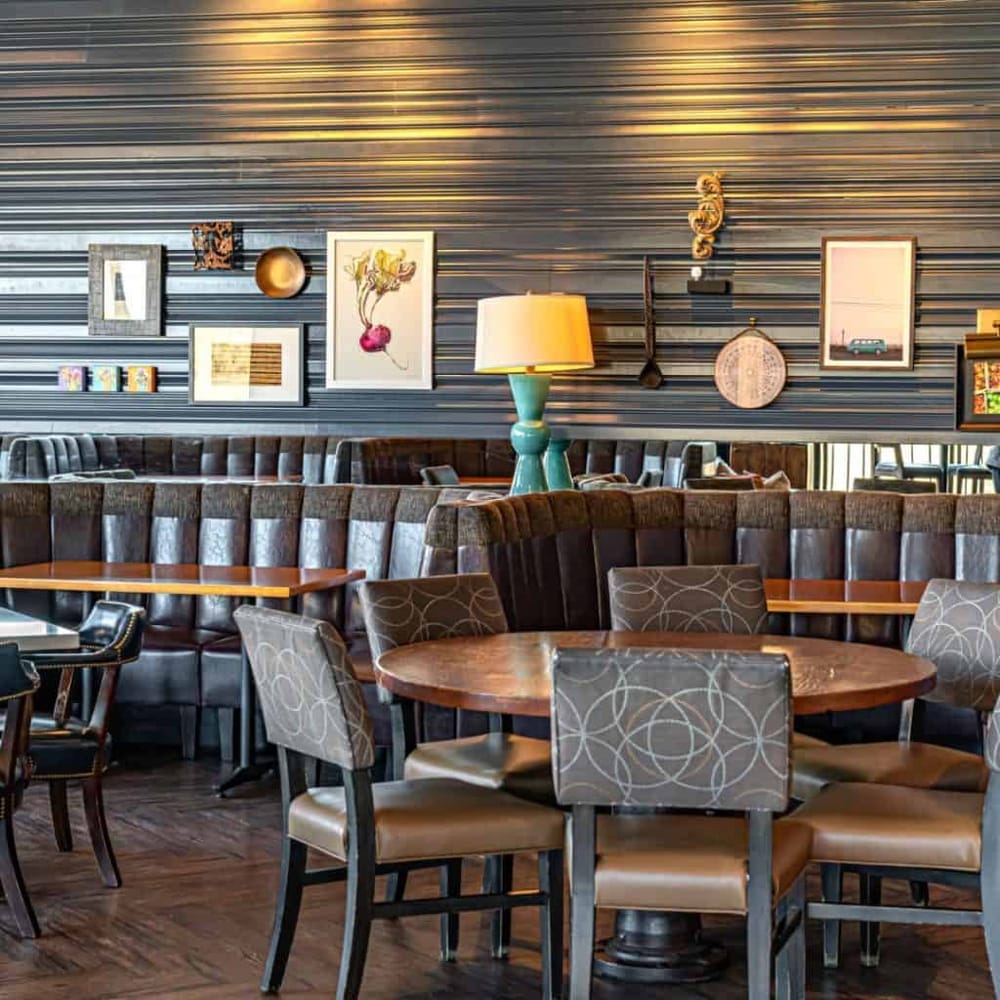 Bright stylish restaurant interior with modern decor and artwork, ideal for dining and socializing.