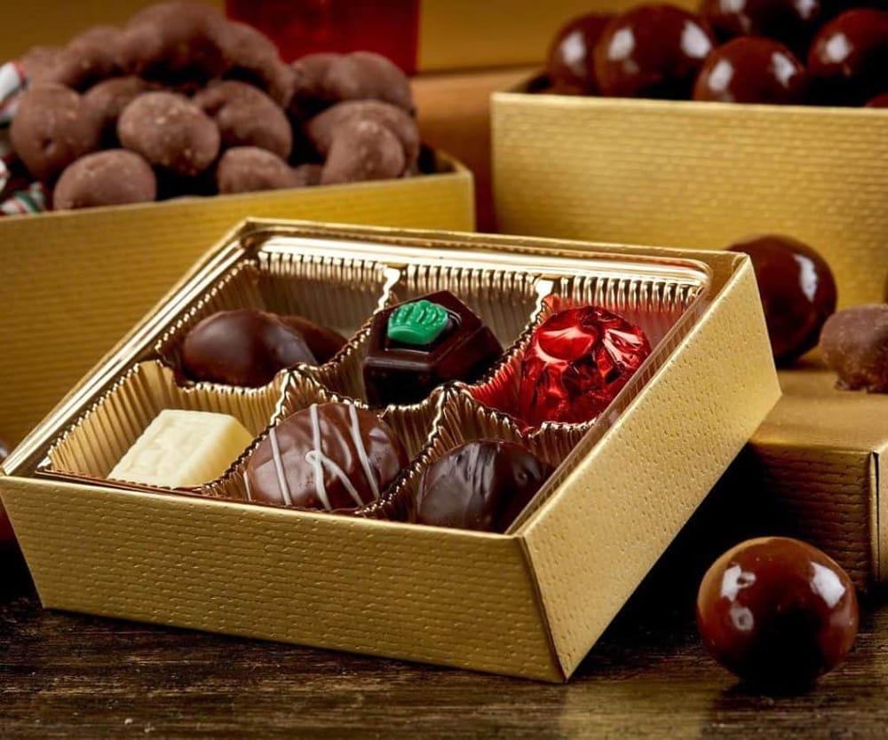 Assorted gourmet chocolates in a gold box for gift ideas and celebrations.