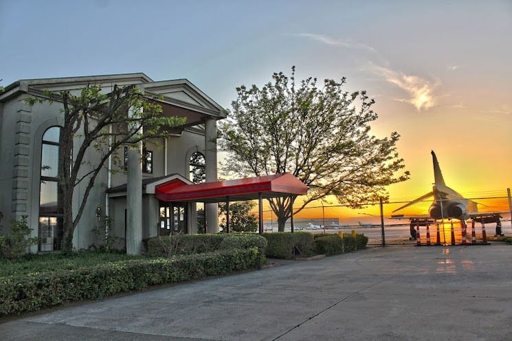 Historic building with airplane display at sunset, fully accessible transportation hub.