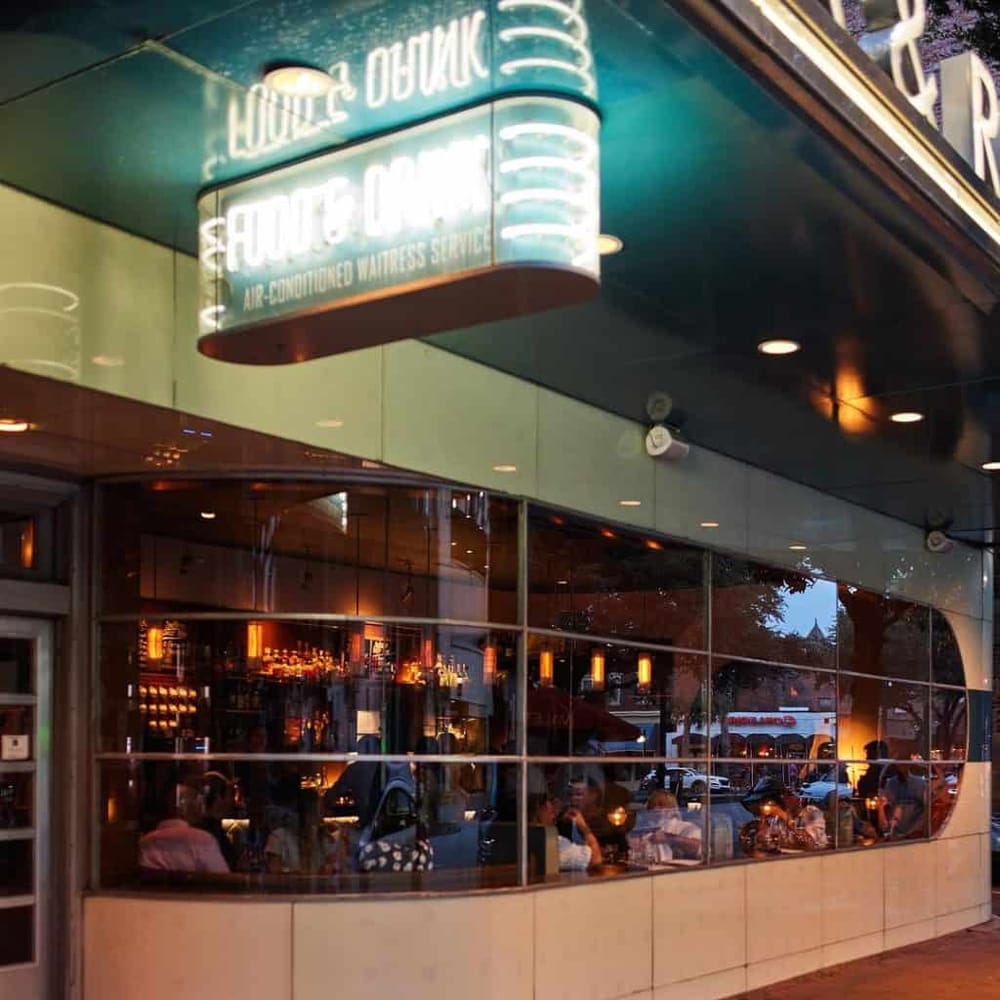 Comfortable restaurant with large windows and warm lighting, perfect for dining and relaxing.