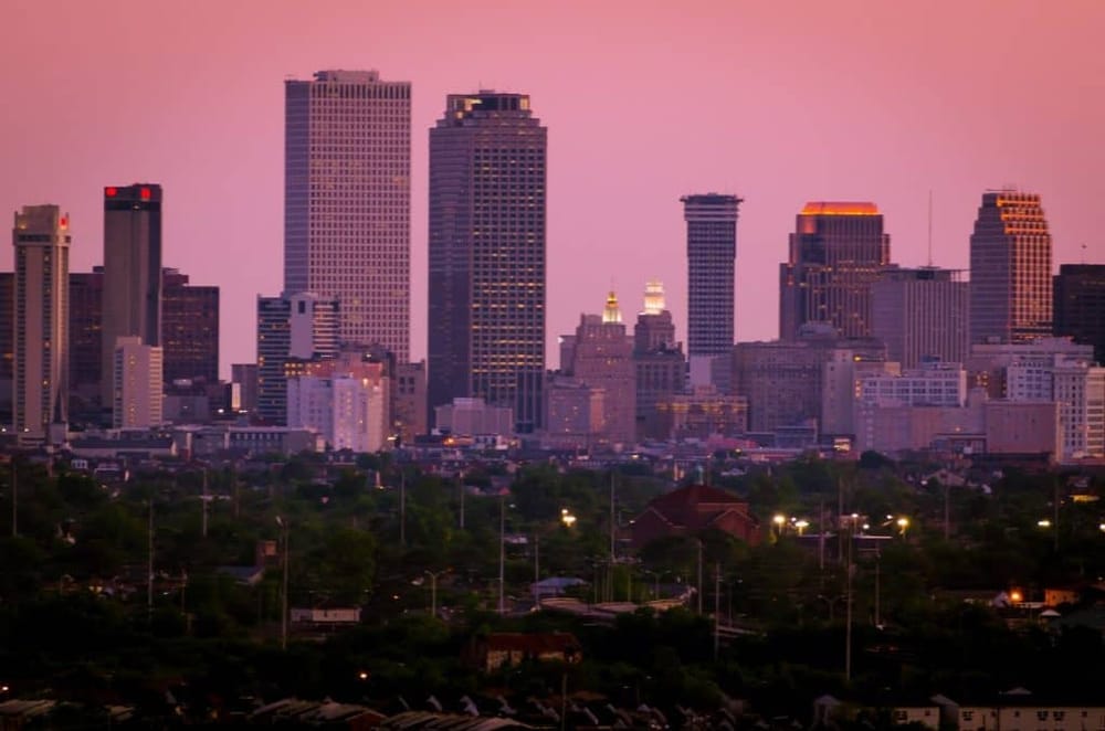 Skyscraper city skyline during sunset with tall buildings and urban landscape.