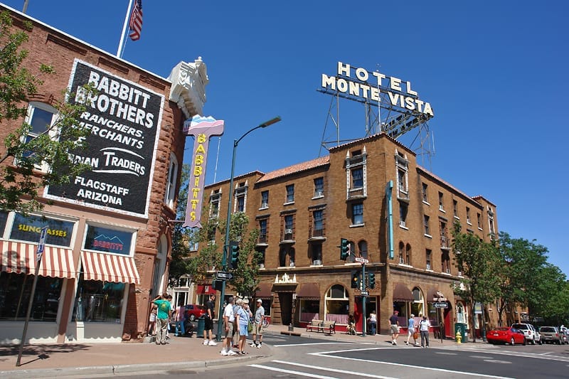 Historic downtown Flagstaff with Hotel Monte Vista and Babbit Brothers signage, Arizona tourism spot.