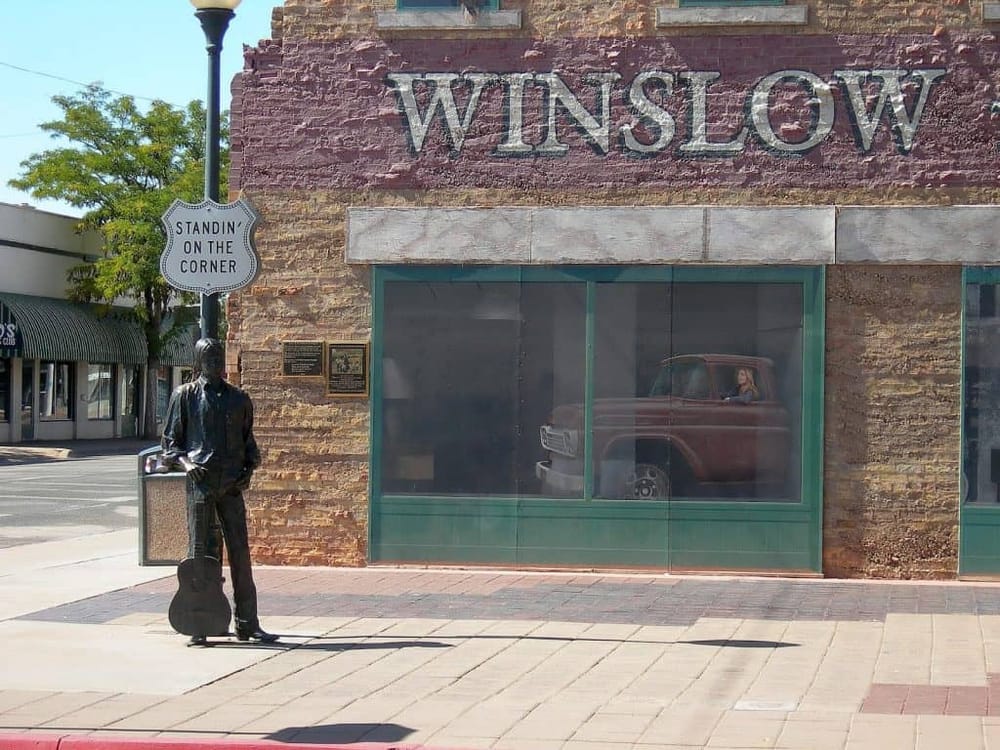 Downtown Winslow, Arizona, historic town with vintage vehicle display in storefront window.