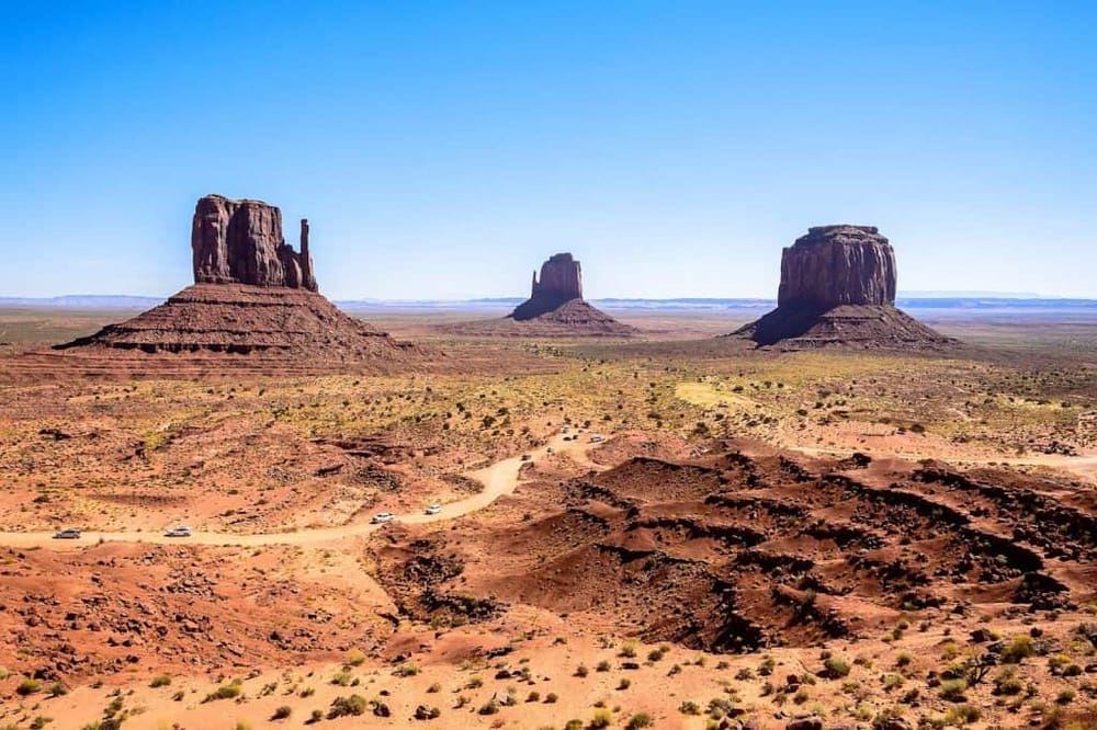 Ancient desert landscape featuring iconic Monument Valley's towering buttes and red rock formations, perfect for travel and adventure enthusiasts.