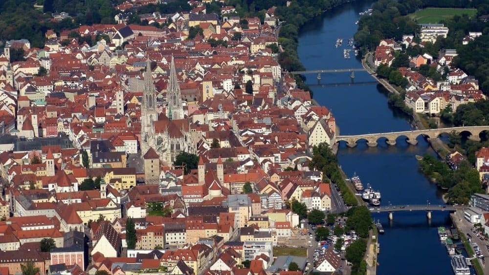 Aerial view of Regensburg, Germany, showcasing historic architecture, the Danube River, and scenic bridges.