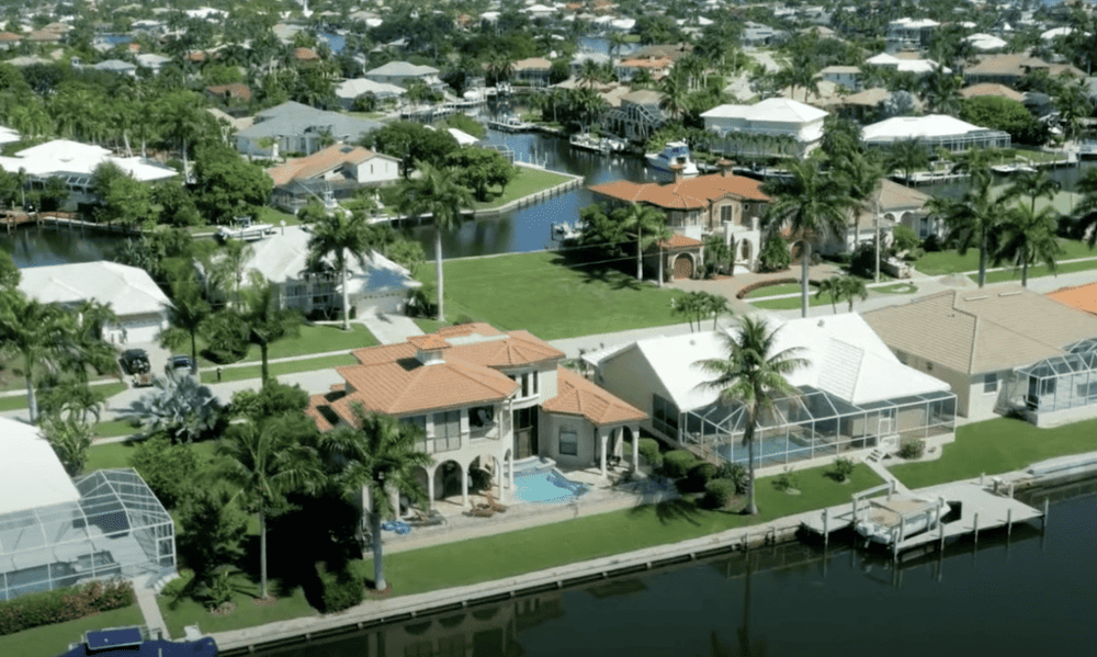Luxurious waterfront homes in Florida with private docks, pools, and lush tropical landscaping.