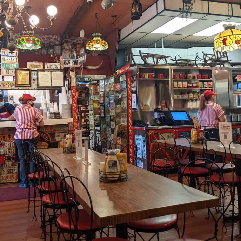 Colorful vintage diner decorated with license plates and neon signs, casual atmosphere, Watkins Glen, NY.
