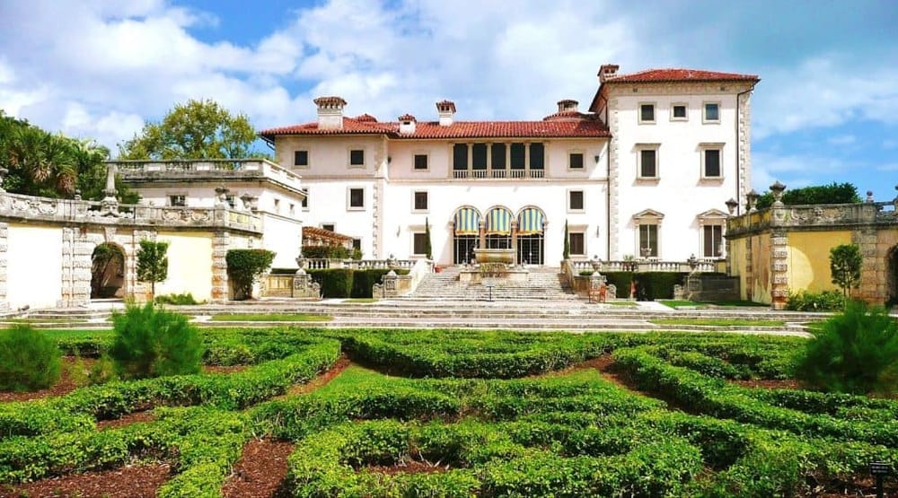 Elegant historic mansion with lush gardens and grand staircase, perfect for weddings and special events.