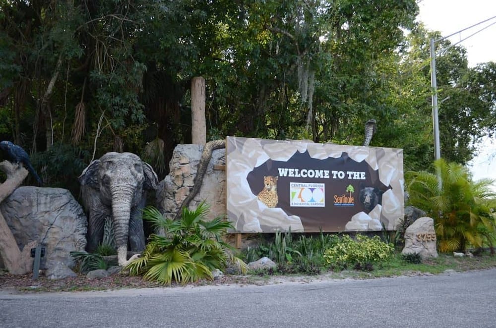 Colorful zoo entrance sign welcoming visitors with jungle and wildlife-themed decor in Central Florida.
