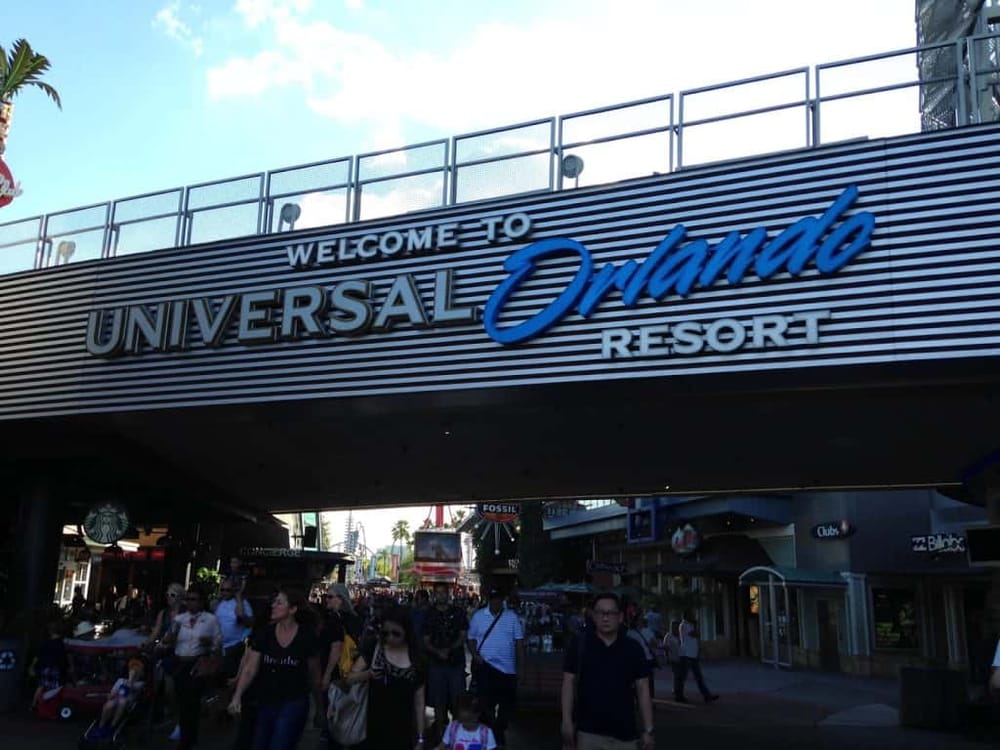 Universal Orlando Resort entrance with crowds and bright signage, popular tourist destination in Orlando, Florida.
