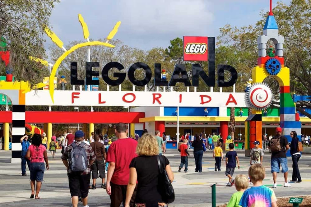 Colorful LEGOLAND Florida entrance with visitors and giant LEGO structures.