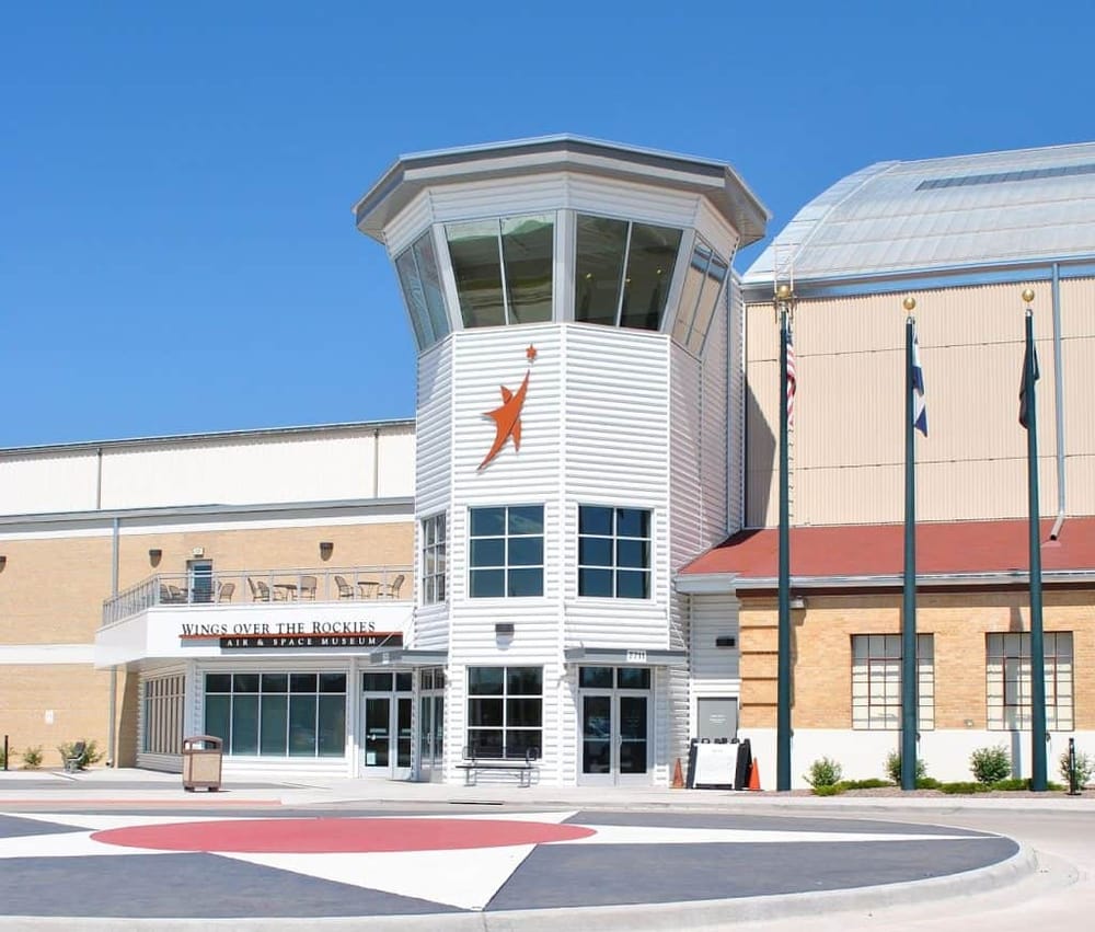 Modern Wings Over the Rockies Air & Space Museum building with clear blue sky, highlighting aviation history at QuestForDirections.