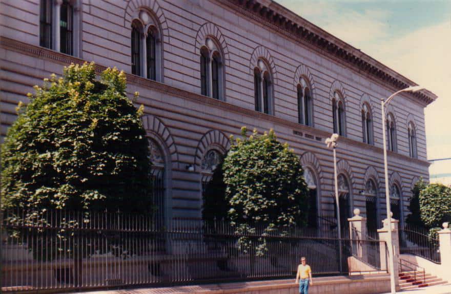 Century-old historic government building with trees outside, located in downtown.