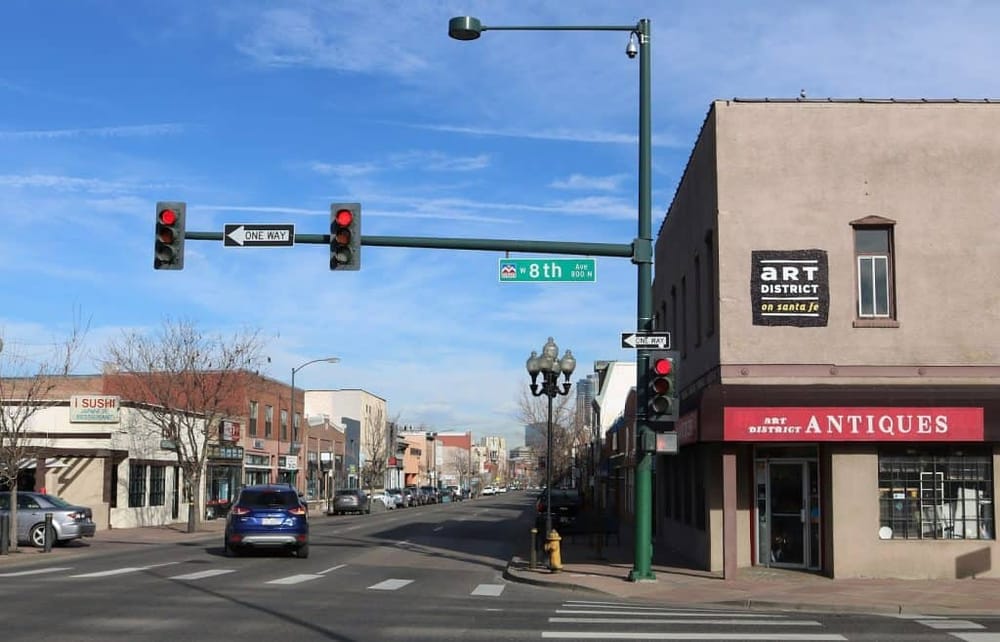 Elevated street view in Santa Fe's Art District with traffic lights and art shops.