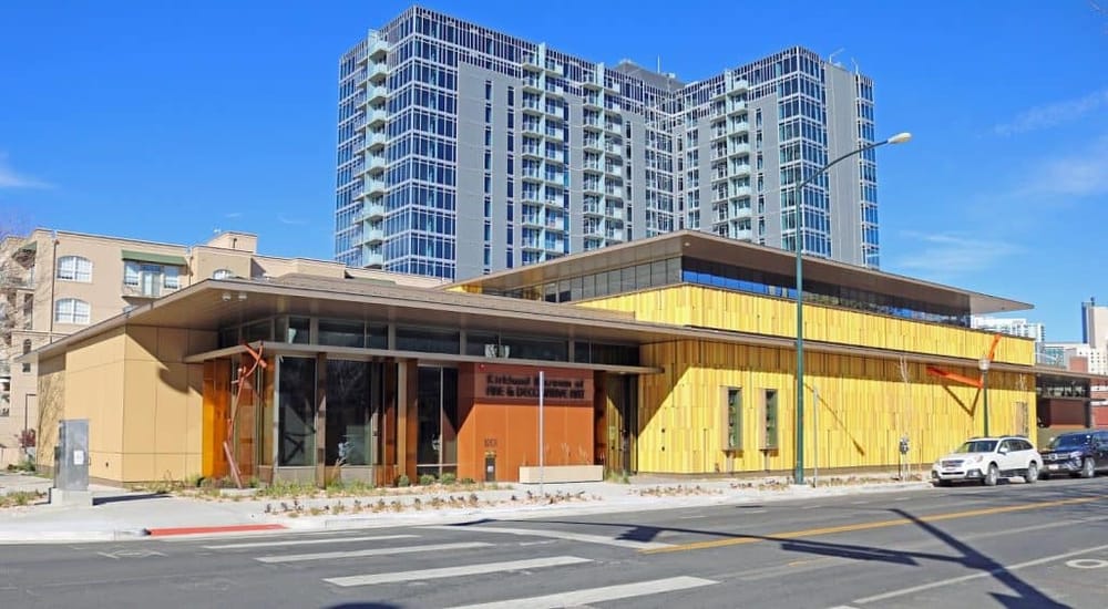 Modern urban library building with colorful exterior, located in a vibrant cityscape.
