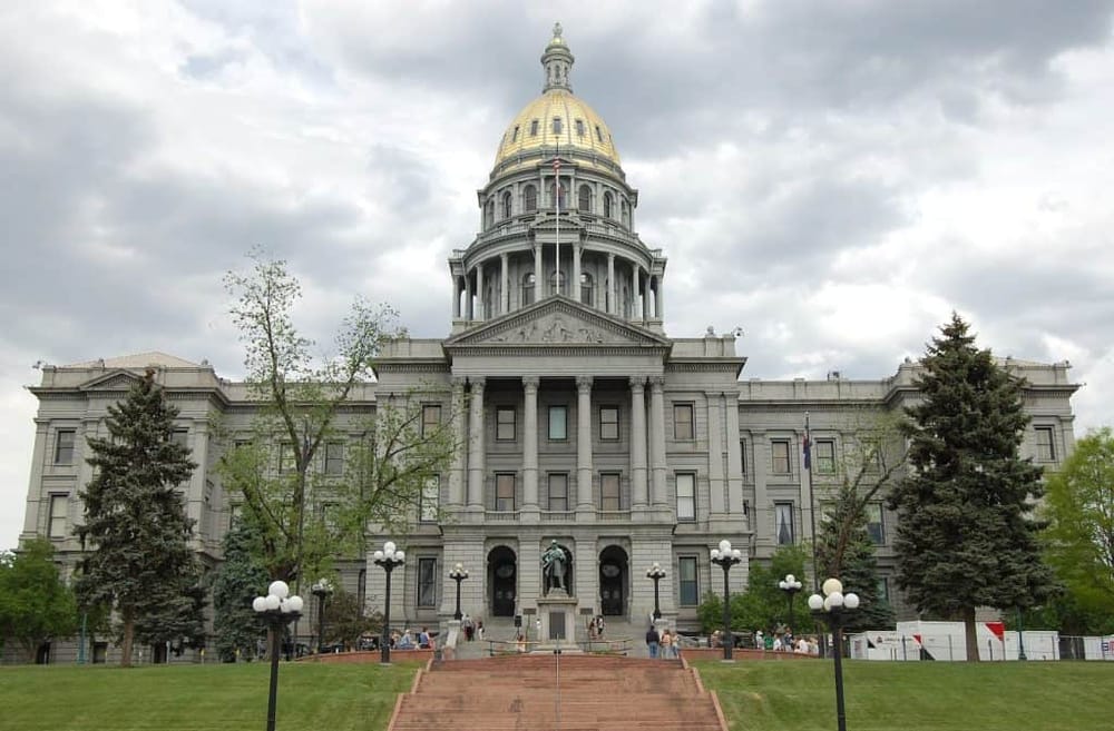 Historic Colorado State Capitol building in Denver, featuring its iconic gold dome and neoclassical architecture.