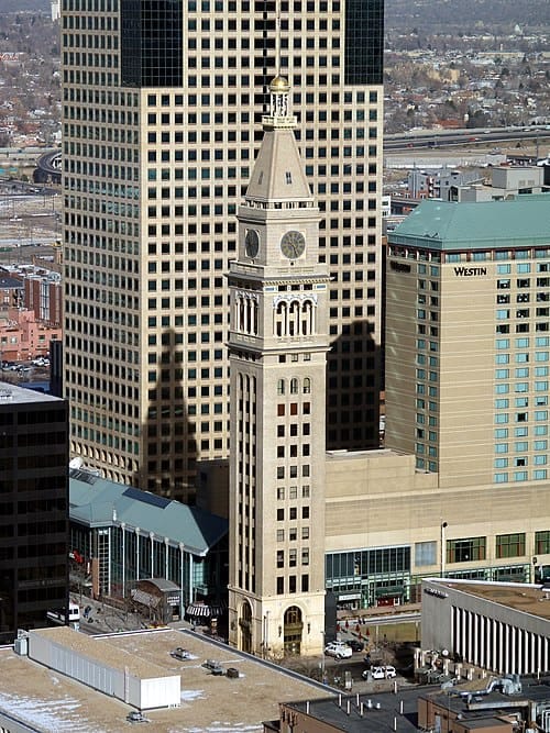 Historic clock tower in downtown city skyline.