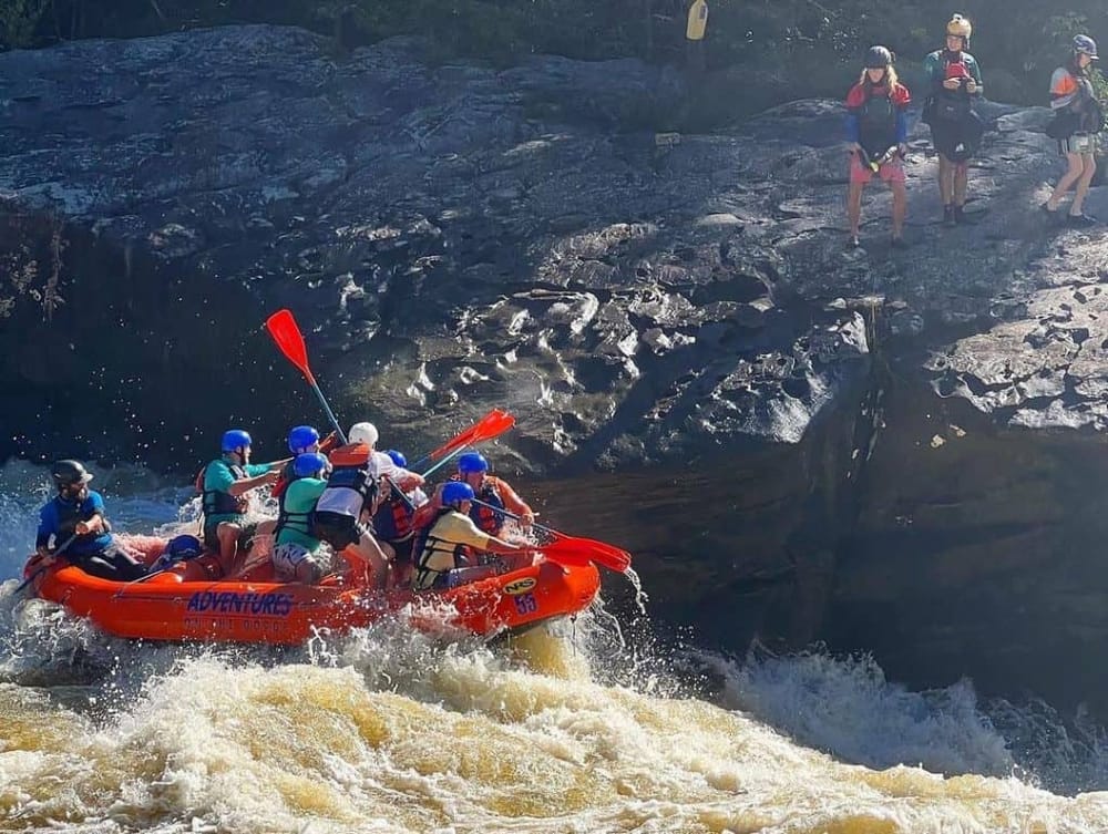 Exciting white water rafting adventure in rugged outdoor terrain with team paddling action.