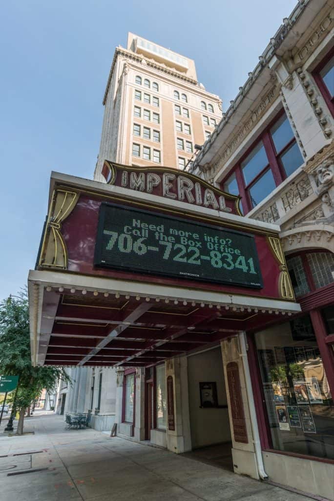 Vintage theater marquee with digital display in downtown city.