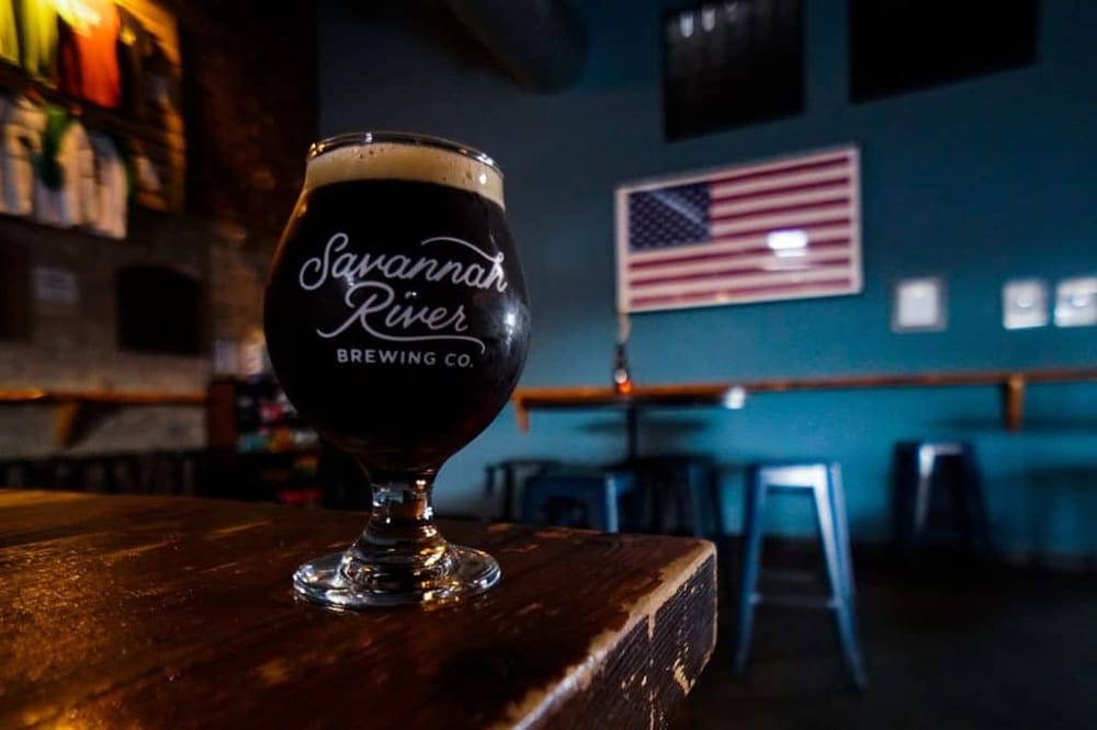 Rich dark craft beer at Savannah River Brewing Co. inside a cozy bar.