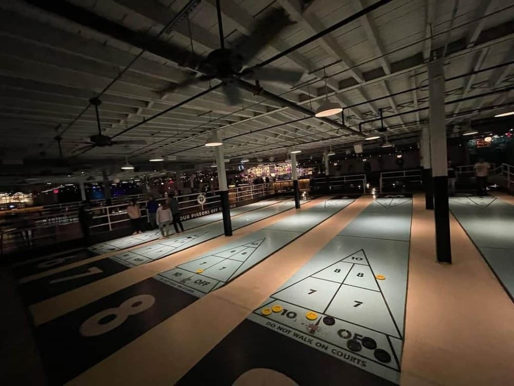 Shuffleboard game at Quest for Directions, an entertainment destination with fun activities.