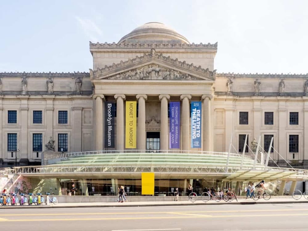 Historic museum building with banners and bicycles outside, representing popular cultural attractions.
