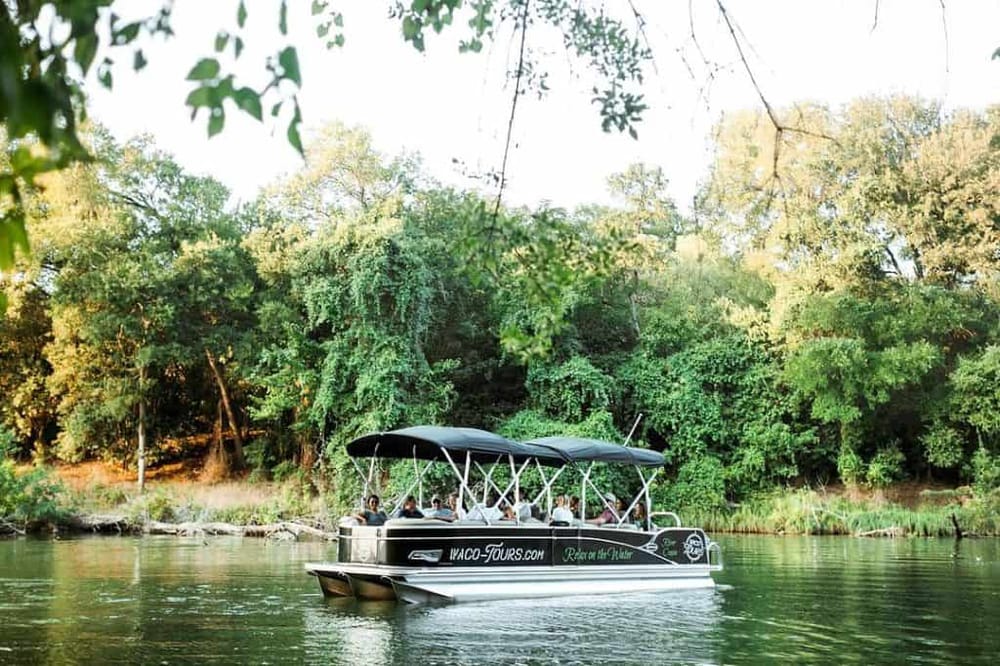 Relaxing boat tour on a scenic river with lush greenery in the background.