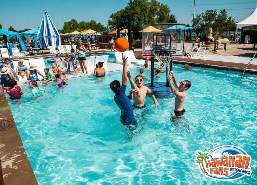 Kids enjoying water games at Hawaiian Falls Waterparks in a lively swimming pool scene, perfect for family fun and aquatic adventure.