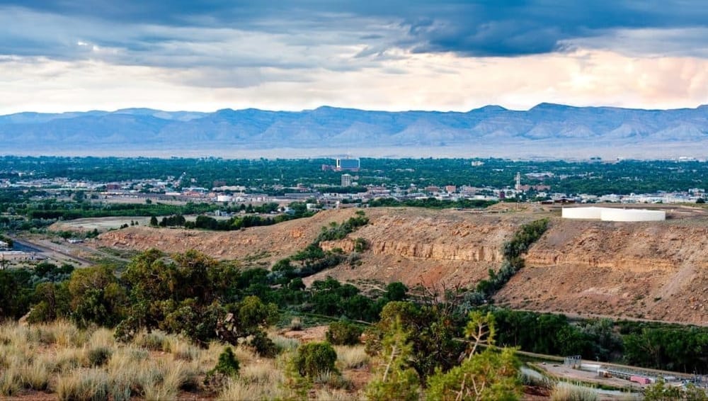 Breathtaking view of Salt Lake City with mountains in the background and desert landscape in the foreground.