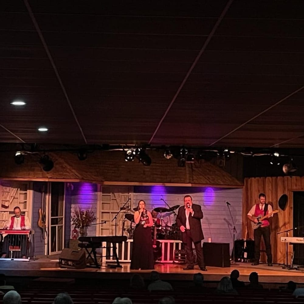 Live band performing on stage at QuestForDirections event venue.