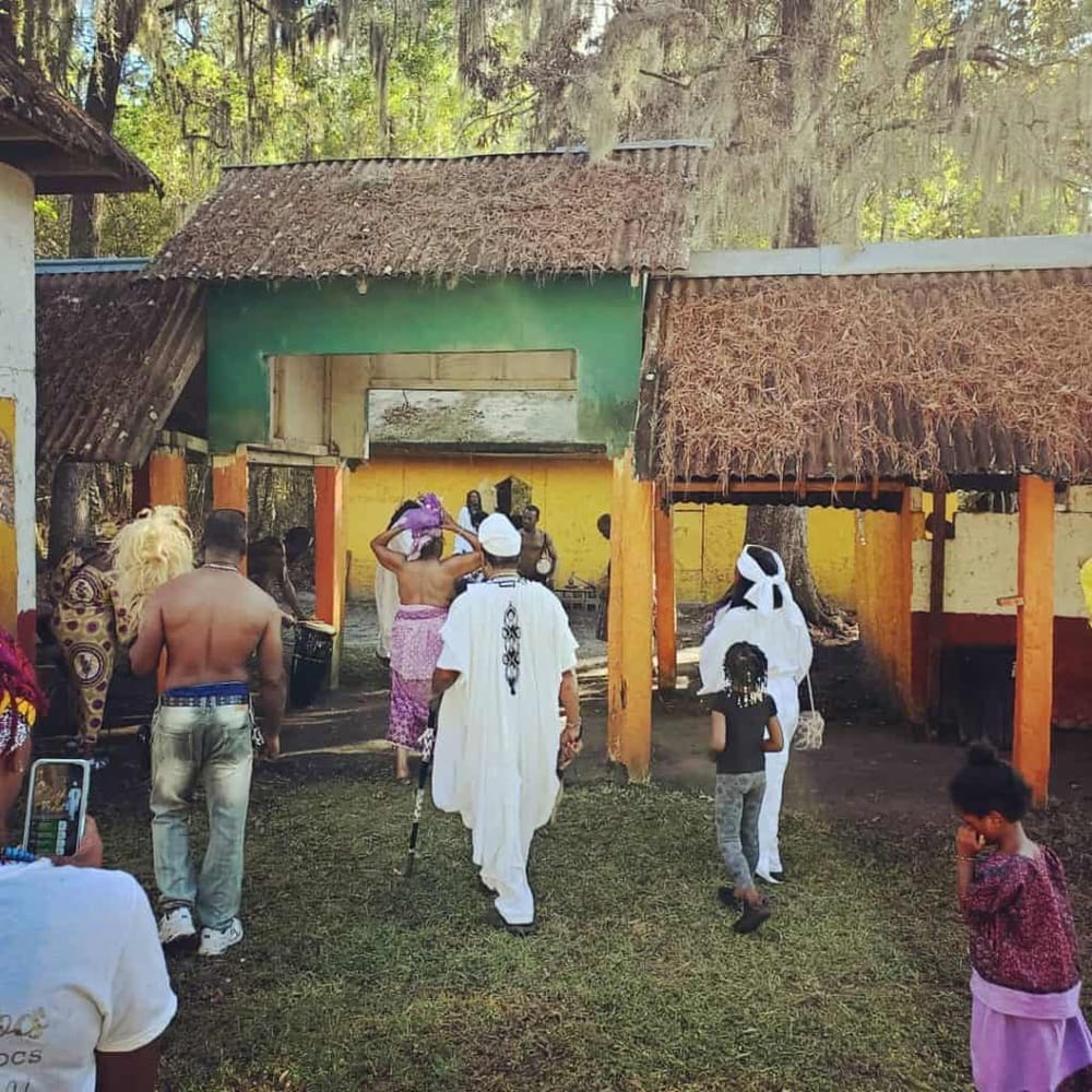 Colorful traditional African community gathering at outdoor cultural site in Africa.