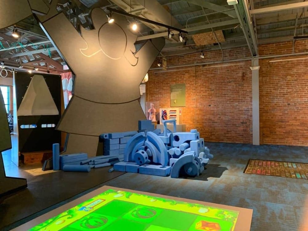 Colorful interactive kids play area with foam blocks and entertainment zone in modern indoor playground.