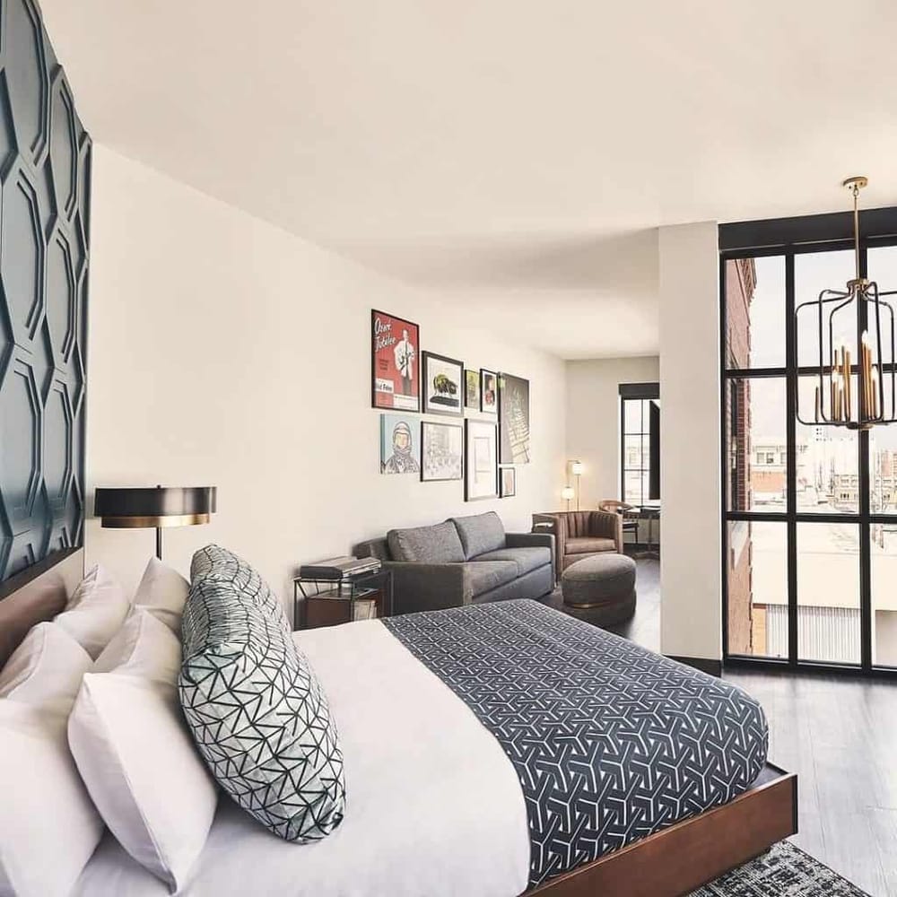 Bright modern apartment with stylish decor, comfortable furniture, and large windows overlooking city views.