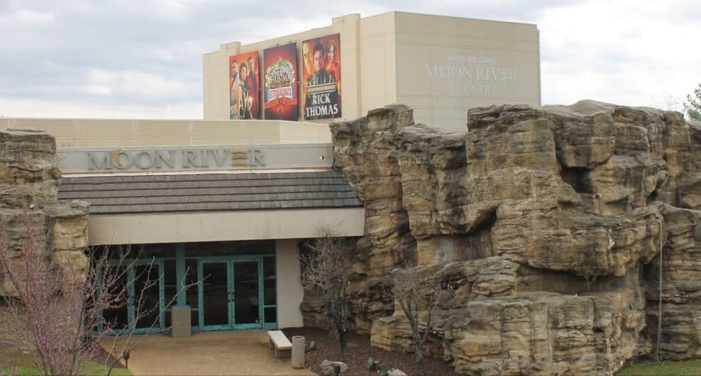 Elegant theater entrance at Moon River with rock formations, perfect for entertainment and events.