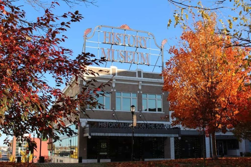 Colorful fall foliage surrounding the historic history museum building.