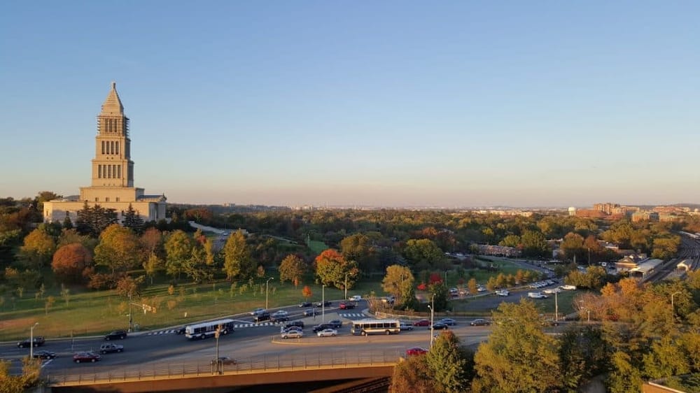 Historic Capitol Building in Austin Texas during golden hour, showcasing cityscape and lush greenery.