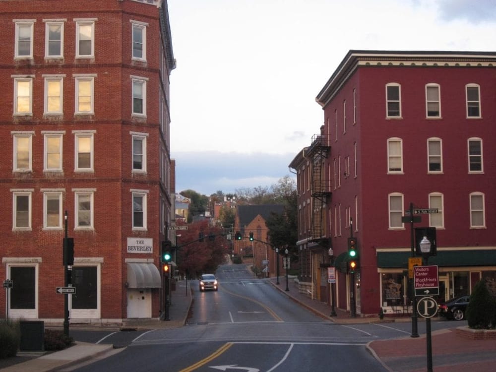 Quiet historic downtown street with brick buildings, traffic lights, and local shops in small-town America.