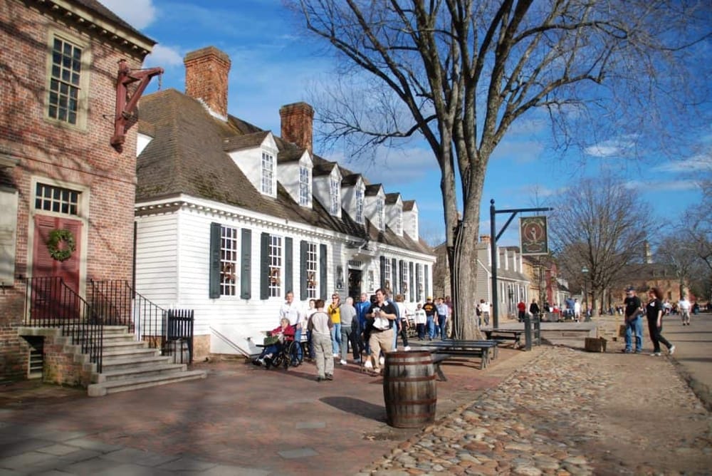 Historic downtown street scene with colonial architecture and tourists exploring, showcasing navigation and directions services.