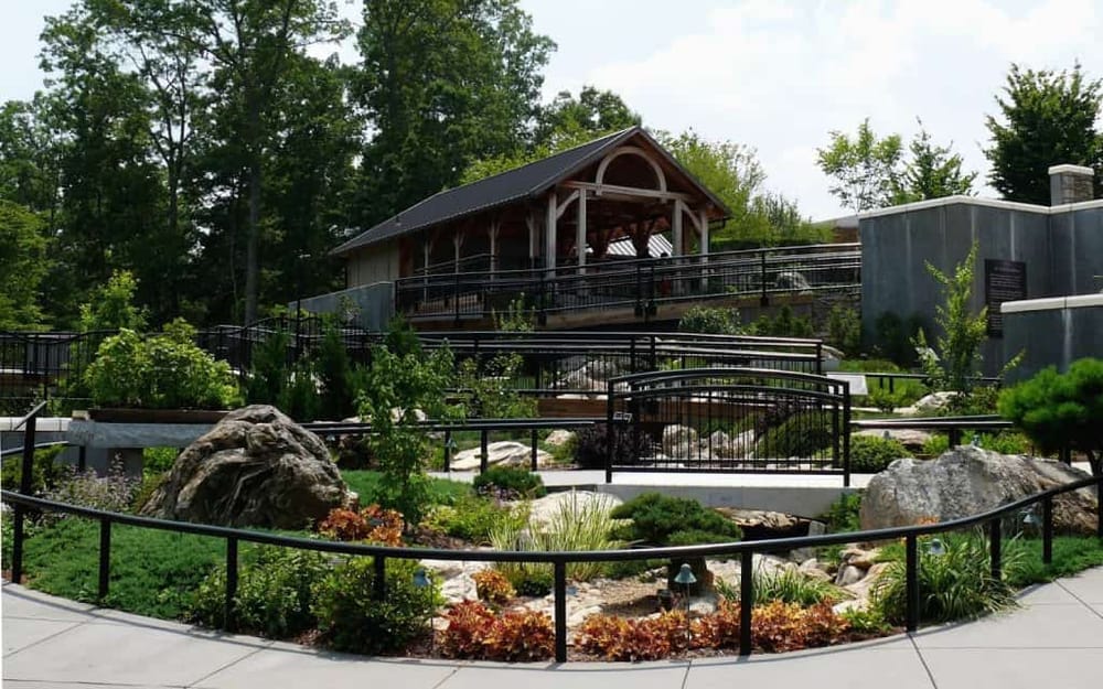 Vibrant tiered botanical garden with winding paths and a rustic pavilion, ideal for nature exploration and outdoor activities.