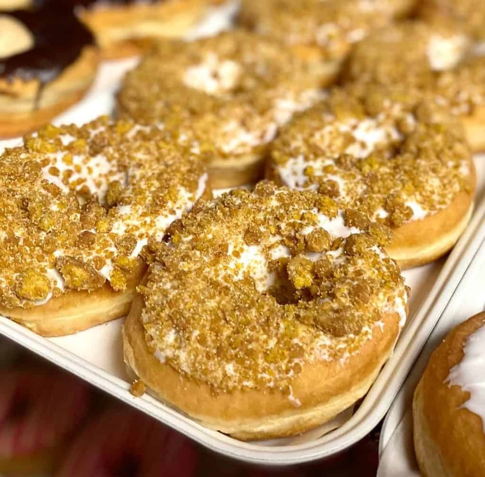 Sweet cinnamon sugar crullers topped with crushed nuts, perfect for breakfast or snack.