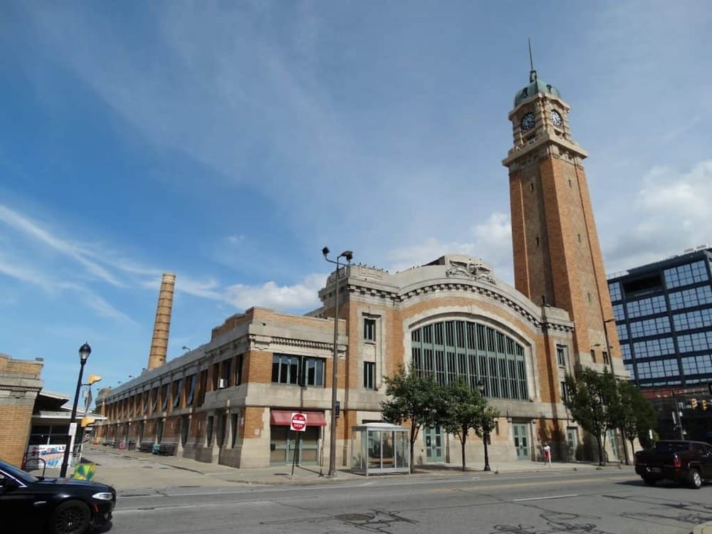 Historic train station with clock tower, in urban downtown setting, city transportation landmark, QuestForDirections.