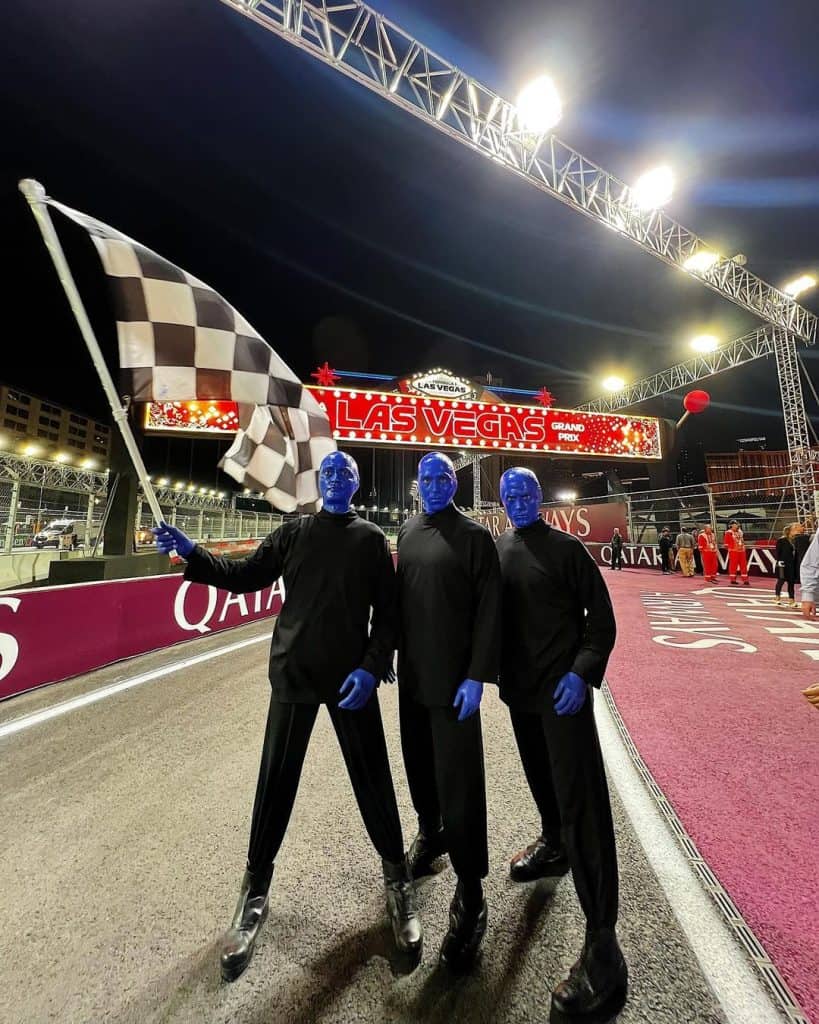 Blue-faced performers at Las Vegas Grand Prix at night, ready for the race event.
