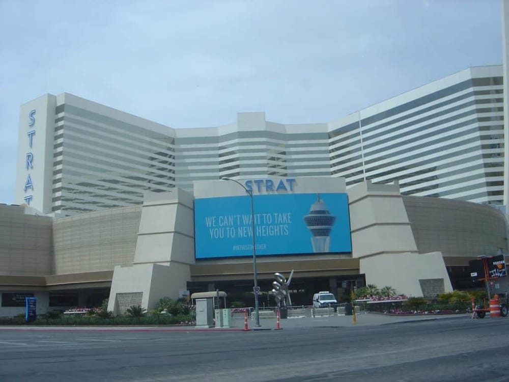 Las Vegas Strip hotel and casino exterior with digital billboard and cityscape view.