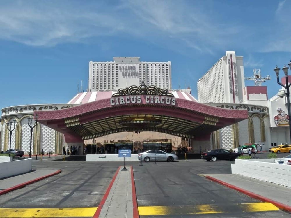 Colorful circus entrance with hotel buildings in the background, Las Vegas entertainment venue.